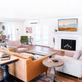 A stylish living room with modern furniture and a cozy fireplace.