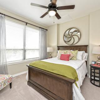A cozy bedroom with modern decor and a comfortable bed.