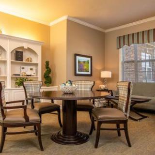 A cozy dining room with elegant furniture and soft lighting.