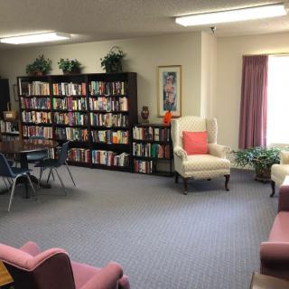 A cozy library space with bookshelves and comfortable seating.