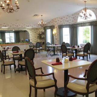 A beautifully designed dining area featuring elegant furniture and ample natural light.