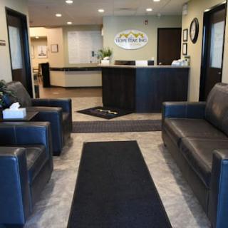 Reception area with sofas and a front desk.