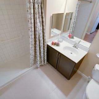 A clean and modern bathroom with a shower curtain, vanity, and sink.