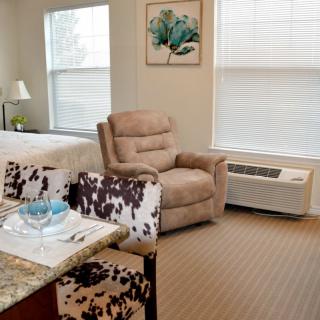 A cozy living room with a recliner and natural lighting.