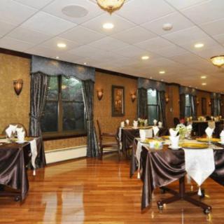 Elegant restaurant dining room with neatly arranged tables and chairs.