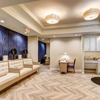 A modern waiting room with comfortable seating and stylish lighting.