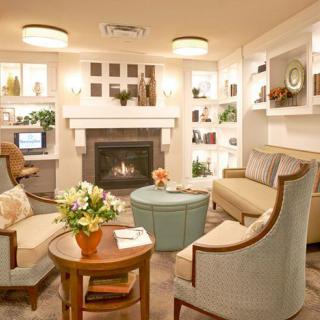 Cozy living room with a warm fireplace and elegant decor.