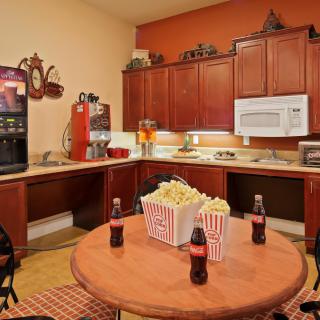 Cozy kitchen setup with popcorn and soda on the table.