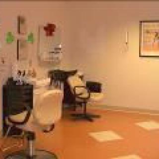 An empty hair salon with chairs and mirrors lined up, ready for clients.