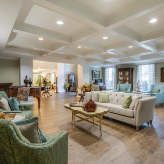 A spacious and elegantly decorated living room with comfortable seating and stylish decor.