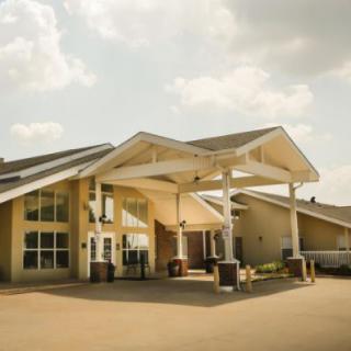 A modern building with a covered entrance on a sunny day.