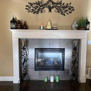 A stylishly decorated fireplace with elegant details and a cozy atmosphere.