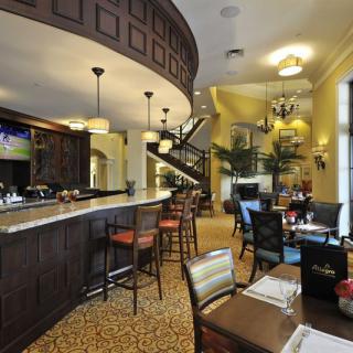 A cozy restaurant interior with a bar and dining area.