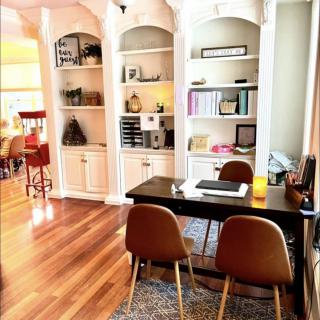 A well-organized home office with built-in bookshelves and a sleek desk setup.