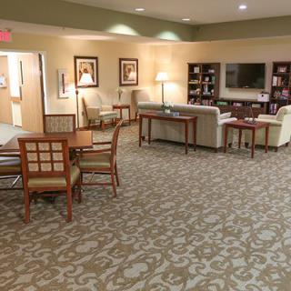 A cozy living room with comfortable seating arrangements and a patterned carpet.