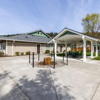A picturesque view of a house exterior with a gazebo and clear skies.