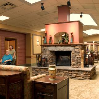 A welcoming lobby with a stone fireplace, providing a cozy environment for residents and visitors.