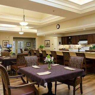 Cozy dining area with a view of the kitchen and neatly arranged tables.