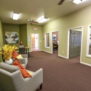 A cozy office lobby with comfortable seating and decorative elements.