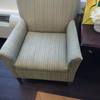 A striped armchair placed in a living room setting.