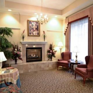 An elegantly decorated living room featuring a fireplace, seating area, and tasteful lighting.