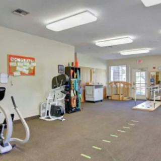 A spacious gym equipped with various exercise machines and equipment.