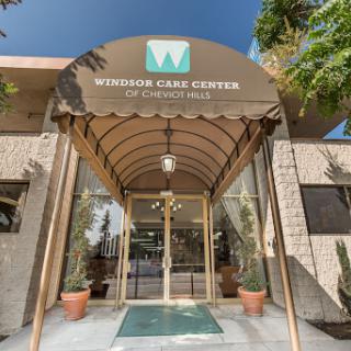 The entrance of Windsor Care Center, featuring an inviting archway and landscaped surroundings.