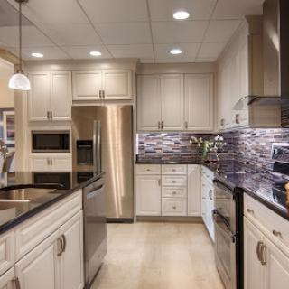 A modern kitchen featuring sleek cabinetry, stainless steel appliances, and elegant lighting.