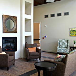 A cozy and modern living room featuring comfortable seating and a fireplace.