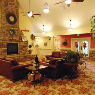 A cozy living room with a fireplace and comfortable seating.