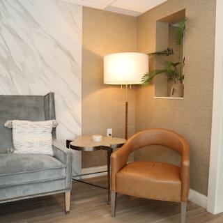 A cozy corner in a modern living room featuring stylish furniture and warm lighting.