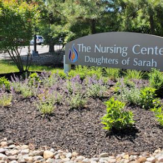 Welcome to The Nursing Center, Daughters of Sarah, surrounded by beautiful landscaping.