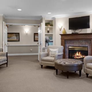 A cozy living room with a fireplace and comfortable seating.