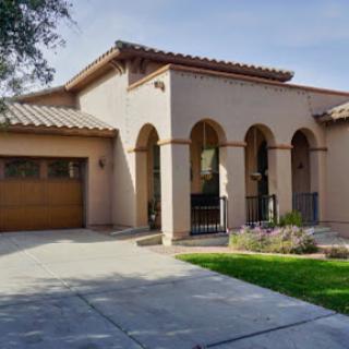 A modern residential house featuring a stylish design and well-maintained landscaping.