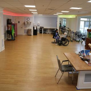 A spacious rehabilitation center equipped with various exercise machines and tools for physical therapy.