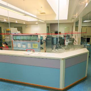 A view of a hospital reception area featuring a modern design and medical equipment.