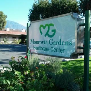 Monrovia Gardens Healthcare Center sign in a landscaped area.