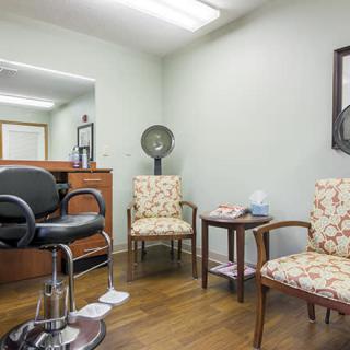 Cozy hair salon interior with a waiting area and styling station.