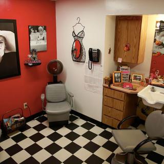 A retro-style hair salon with a checkered floor and red and white decor.