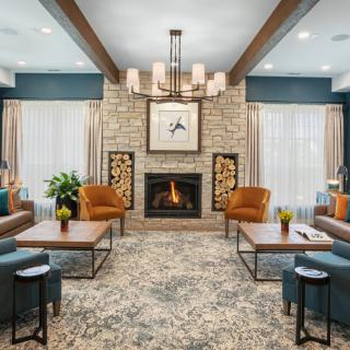 A modern living room featuring a cozy fireplace, comfortable seating, and elegant interior decor.