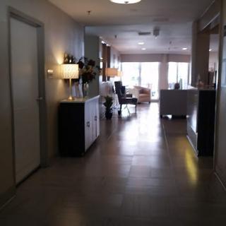 A modern hallway with stylish furniture and warm lighting.