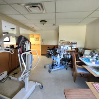 A view of a hospital room equipped with various medical and rehabilitation devices.