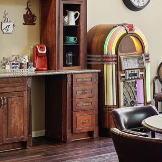 A cozy kitchen corner featuring a vintage jukebox and a modern coffee station.