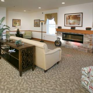 A cozy living room featuring a comfortable sofa, modern decor, and a fireplace.