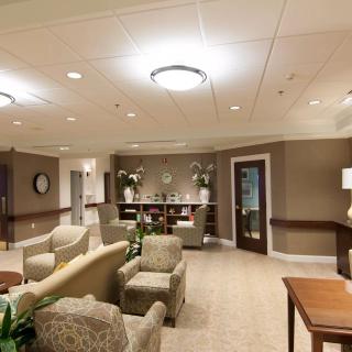 A spacious and well-lit waiting room featuring comfortable seating and elegant decor.