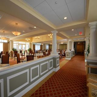 Elegant dining area with tables, chairs, and chandeliers.