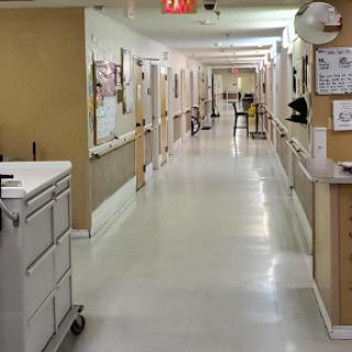 A view of a hospital hallway, showcasing the clean and organized environment typical of medical facilities.