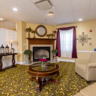 A cozy living room featuring a fireplace, elegant furniture, and tasteful decor.