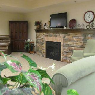Cozy living room with a stone fireplace and modern decor.