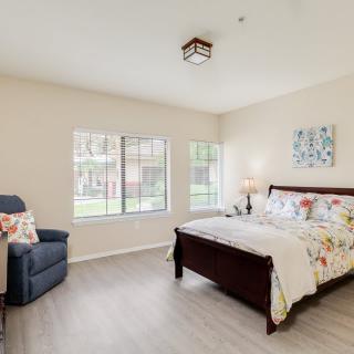 A cozy bedroom with a large window and stylish decor.